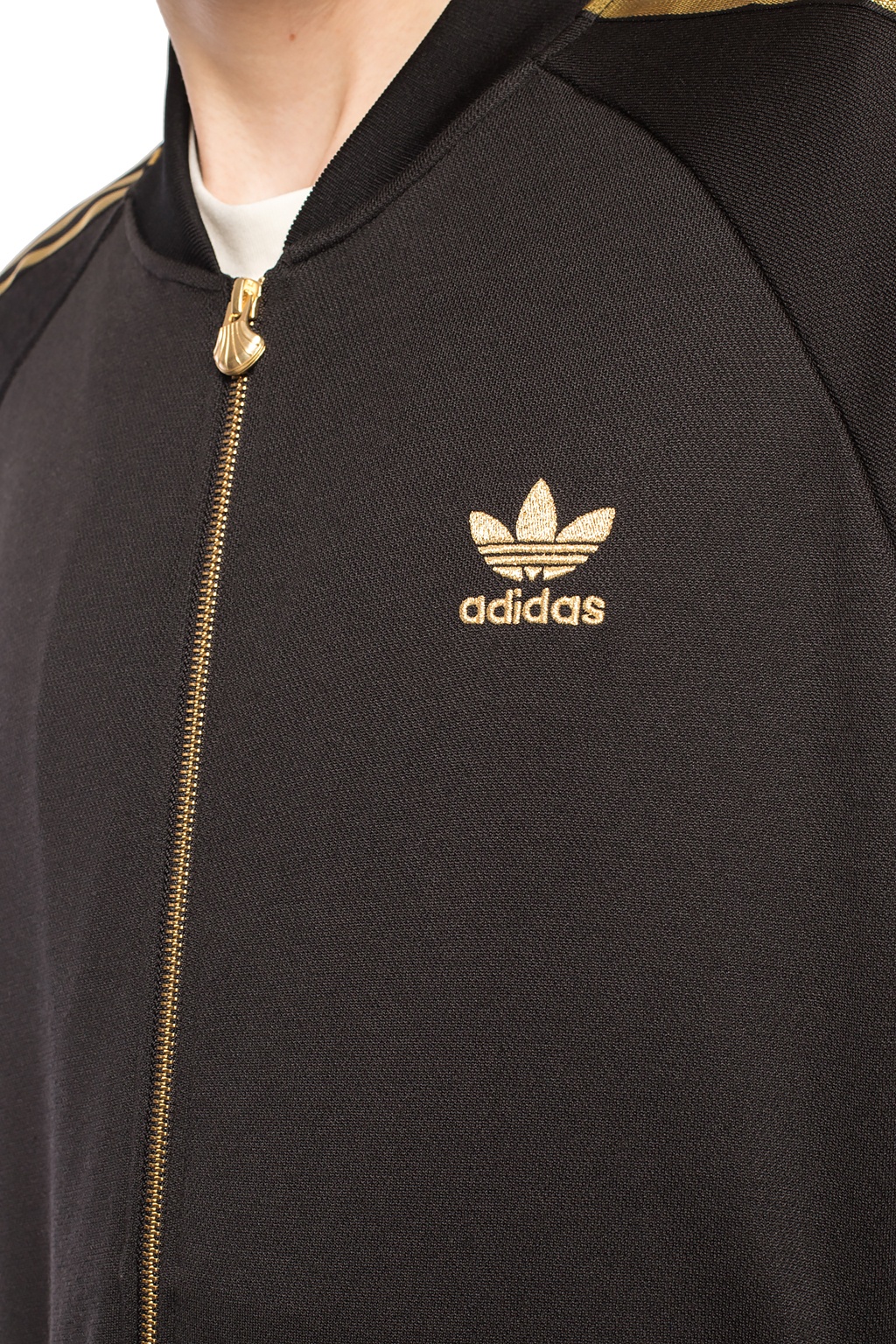 Adidas superstar black clearance and gold track top